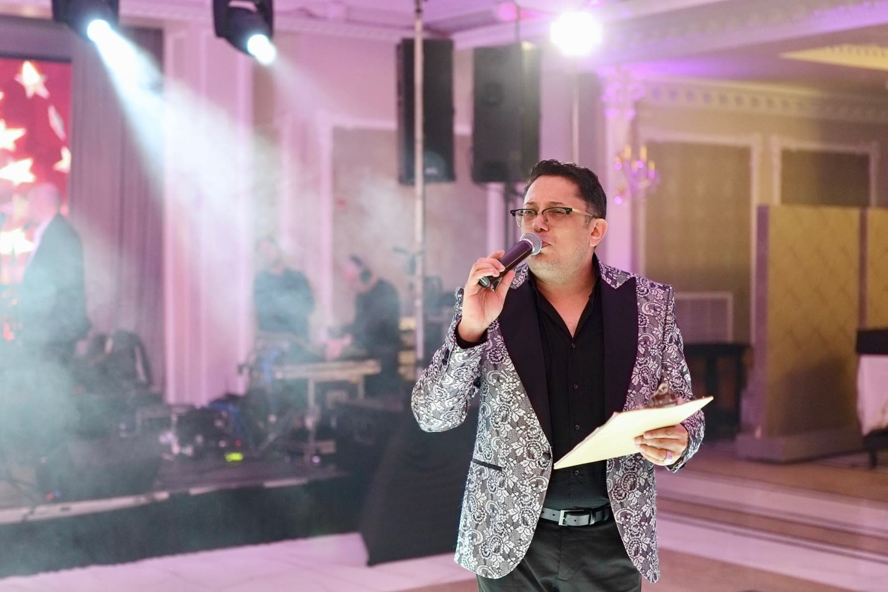 Lazar hosting an event with a microphone
